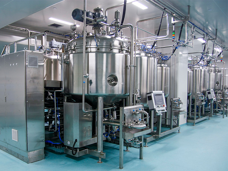 Industrial stainless steel reactor and nutsche filter dryer setup in a cleanroom environment, featuring vacuum emulsification tanks and mixing tanks for precise chemical processing.